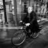 A typical Parisian commuter riding a bicycle. An everyday affair in Paris. Taken whilst on a moving van. Paris, France, May 2012