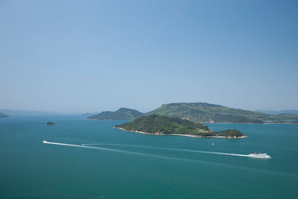 Image of small islands in japan with blue sea and boats