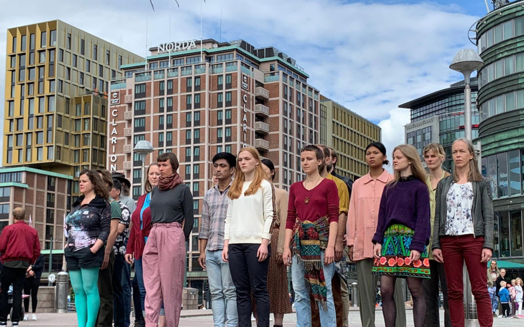 group of people in a city space looking at public