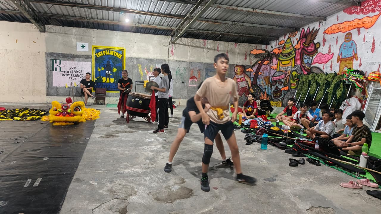 Children practise barongsai (lion dance) in a room at the back of Rumah Banjarsari