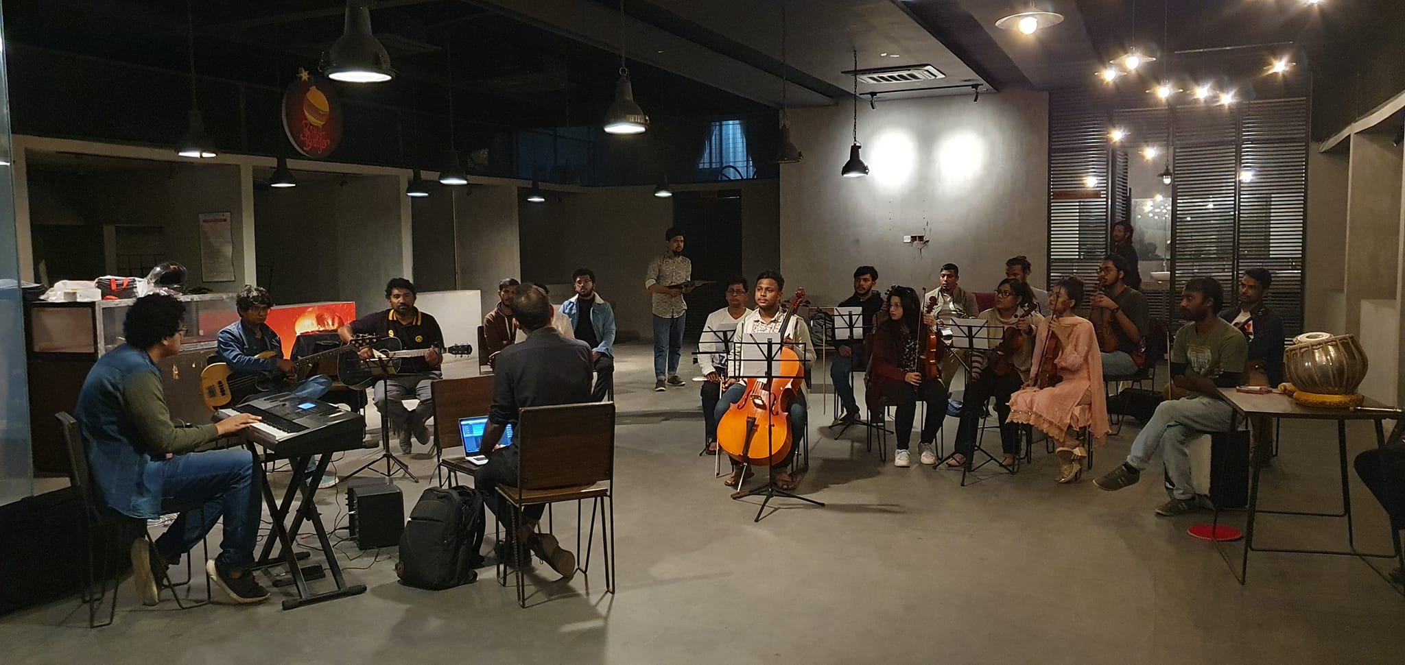 Musicians rehearsing together in a studio environment, demonstrating collaborative listening and ensemble coordination.