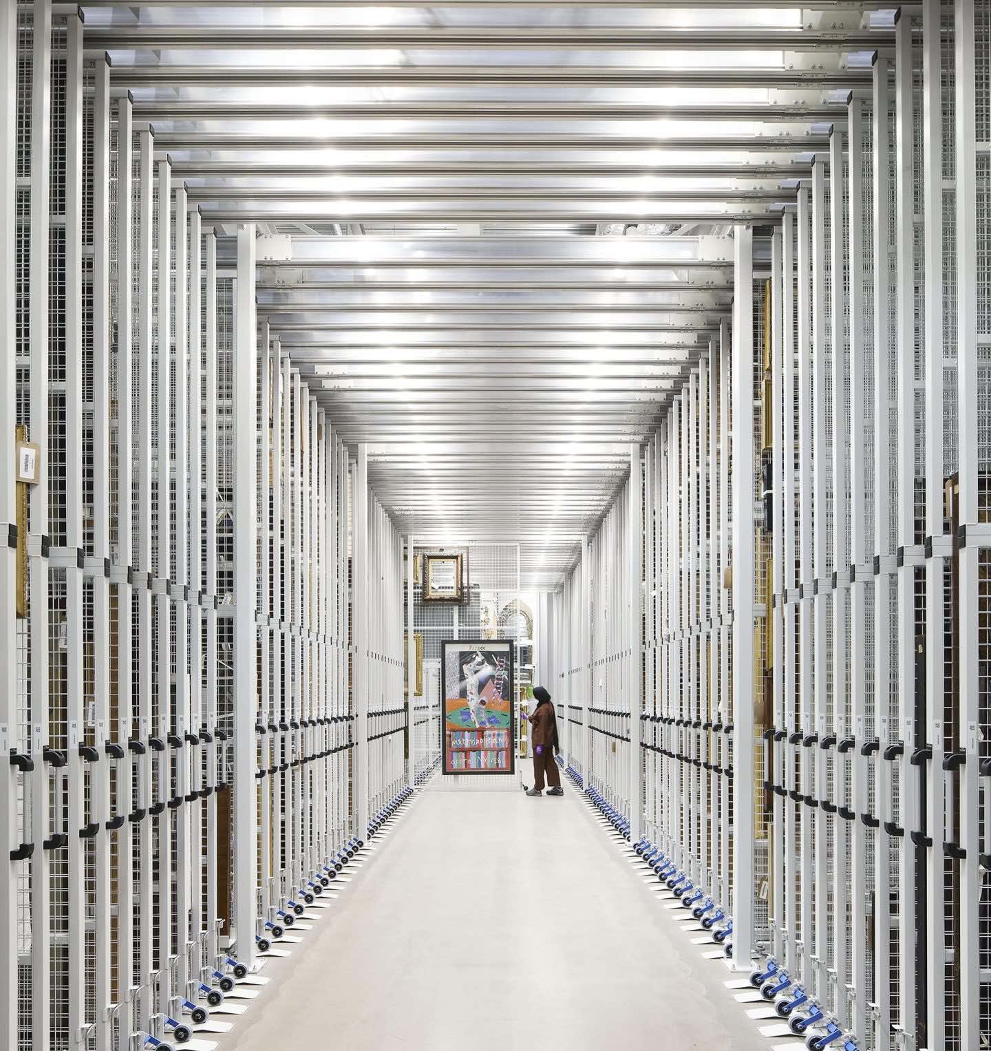 A storage corridor with some paintings being pulled out.