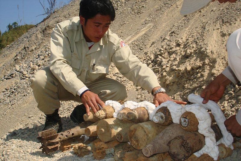 UXO_Lao_SEOD_technition_preparing_UXO_for_destruction,_2007._Photo-_Steffen_Peter_UXO_Lao_(10684436376)